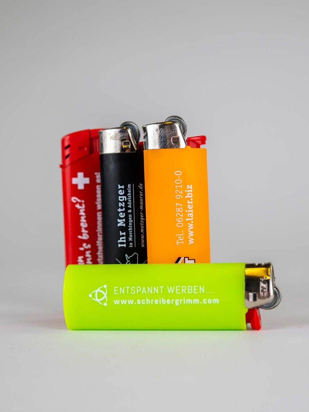 rotes, schwarzes, orange farbenes und grünes Feuerzeug